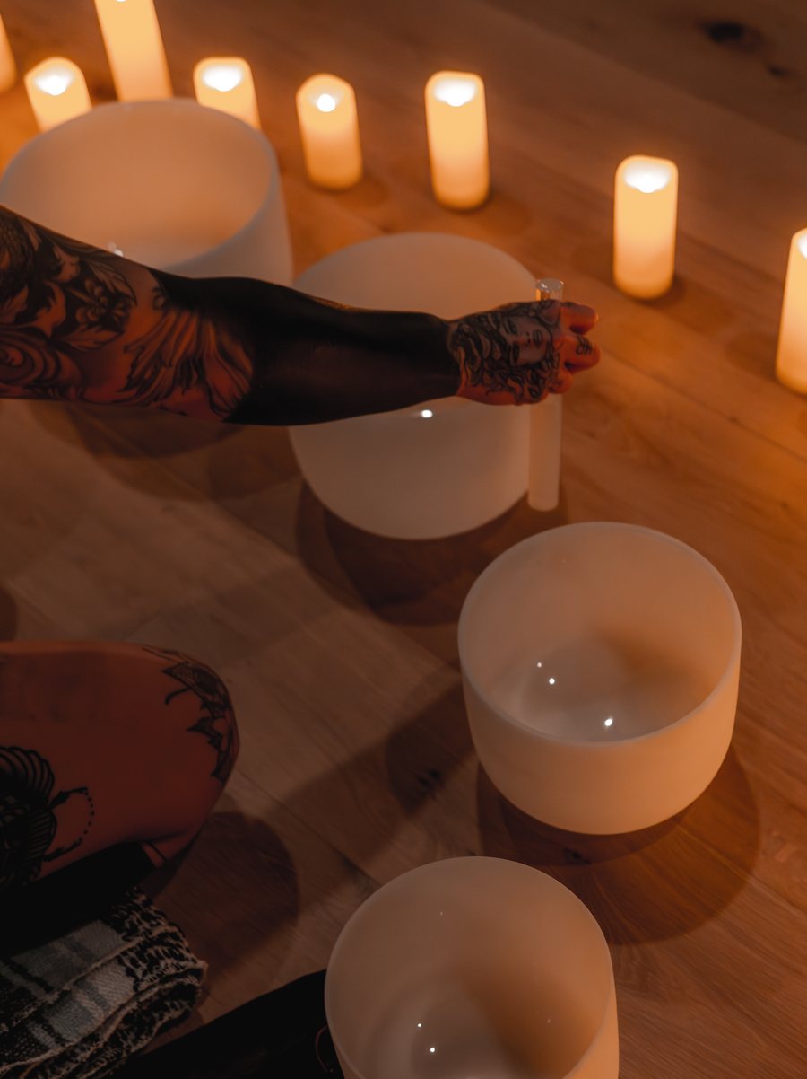 Crystal singing bowls arranged by candlelight in the studio
